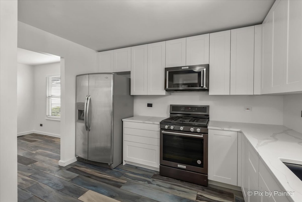1812 Arbor Fields Drive Plainfield, IL 60586 - Photo 6 of 35 a kitchen with stainless steel appliances white cabinets and a stove top oven