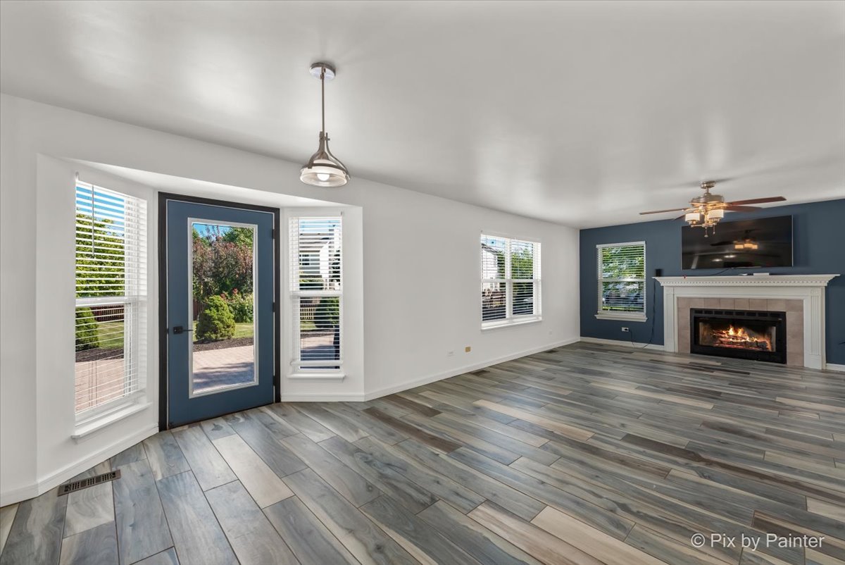 1812 Arbor Fields Drive Plainfield, IL 60586 - Photo 8 of 35 a view of an empty room with wooden floor fireplace and a window