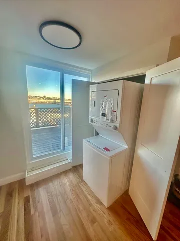 a view of a room with wooden floor and sink