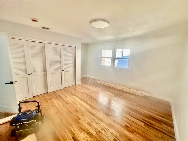 a view of a livingroom with wooden floor and a window