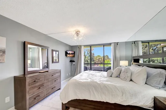 a bedroom with a large bed and a dresser