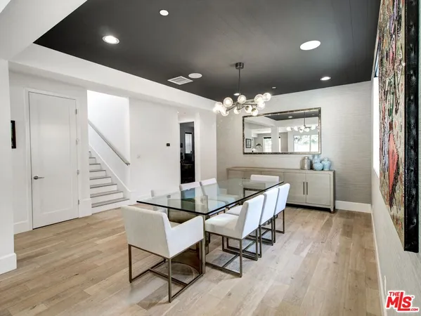 a view of a livingroom with furniture a ceiling fan and wooden floor