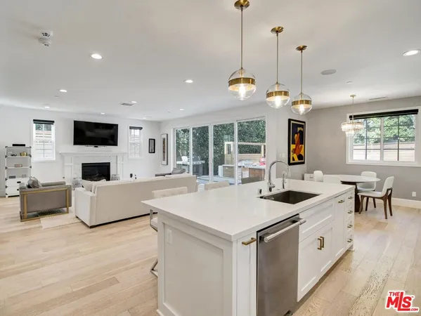 a kitchen with stainless steel appliances granite countertop a stove and a refrigerator