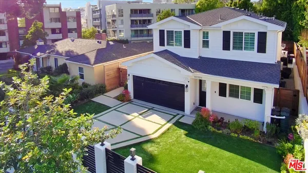a aerial view of a house with a yard and potted plants