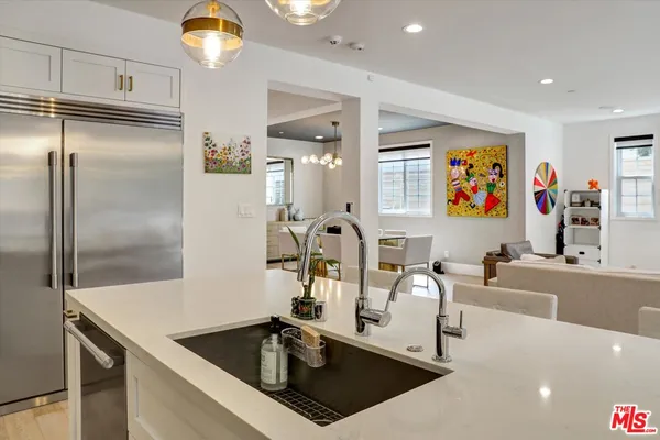 a kitchen with a dining table chairs and white cabinets