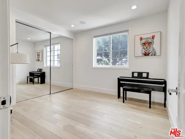 a large bed sitting in a bedroom next to a window