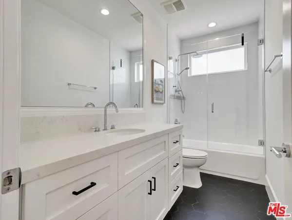 a kitchen with stainless steel appliances a refrigerator and window