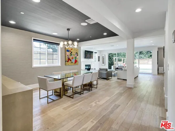 a living room with furniture a wooden floor and chandelier