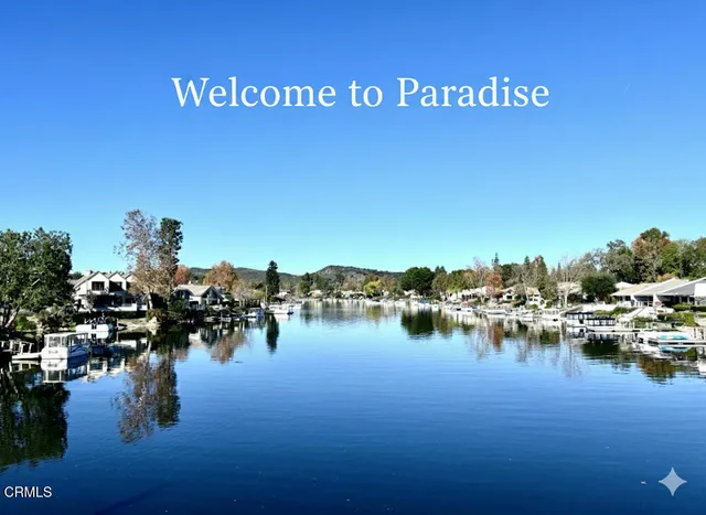 an aerial view of a house with swimming pool patio and lake view