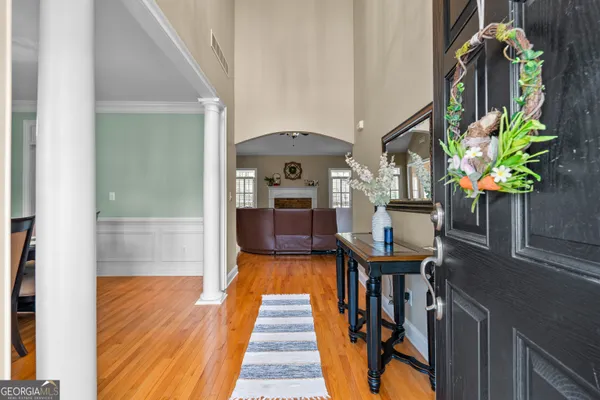 a kitchen with stainless steel appliances granite countertop a stove a refrigerator a kitchen island a dining table and chairs