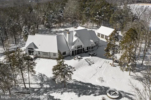 a view of a house with a yard covered with snow in the background