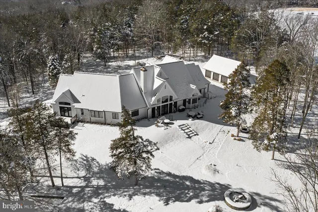 a view of a house with a yard covered with snow in the background