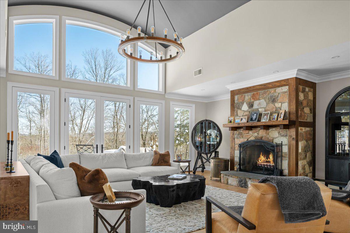 2 Cedar Lane Erwinna, PA 18920 - Photo 48 of 69 a living room with furniture a chandelier and a fireplace