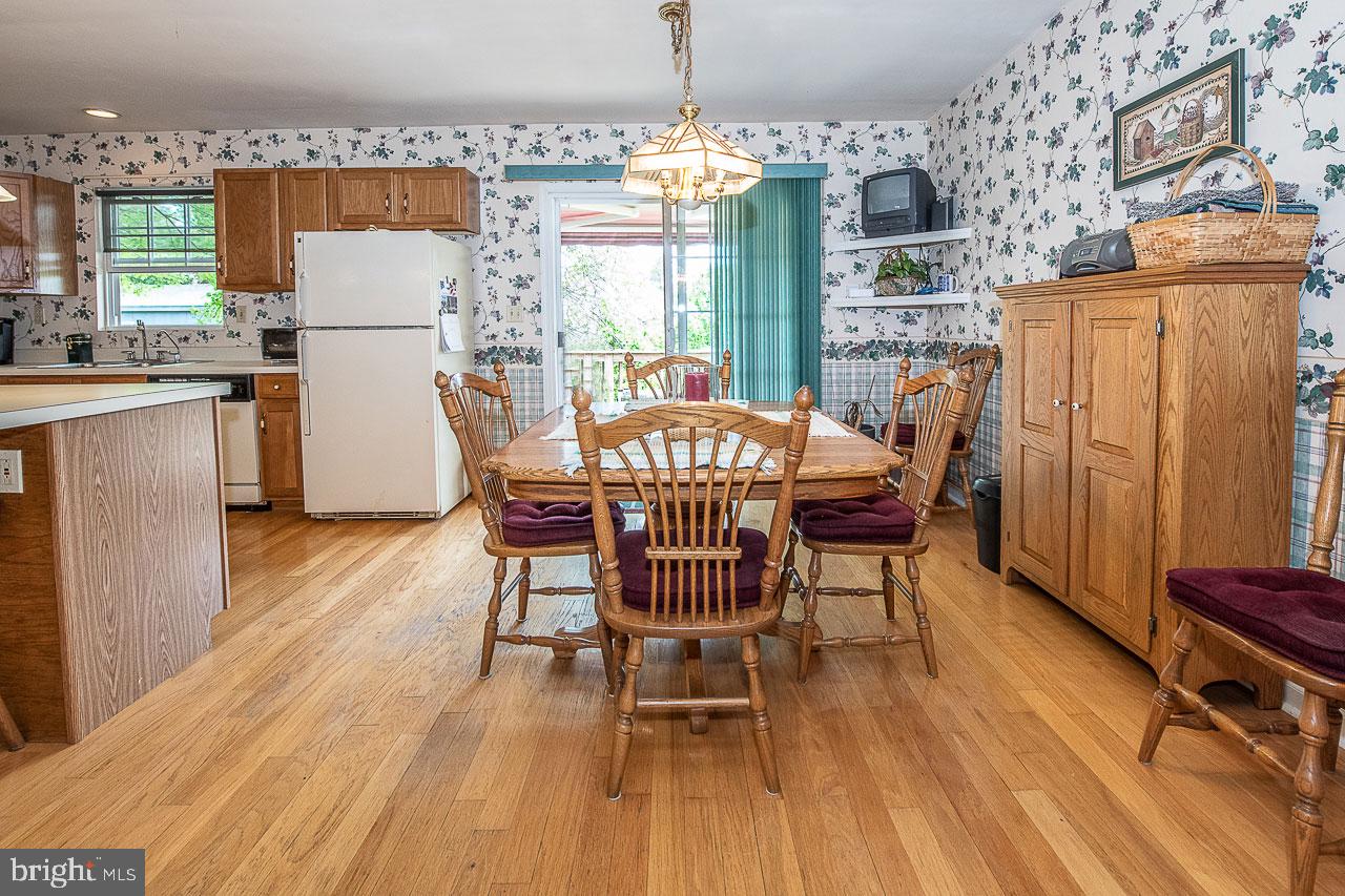 527 Schick Road Aston, PA 19014 - Photo 11 of 28 a dining room with furniture a chandelier and wooden floor