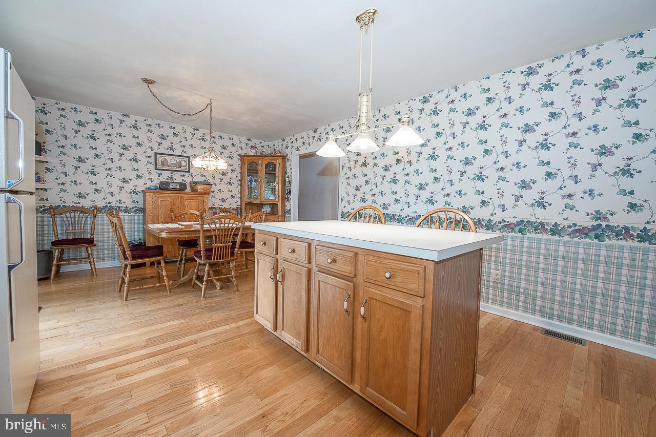 527 Schick Road Aston, PA 19014 - Photo 14 of 28 a kitchen with stainless steel appliances wooden floor and a sink