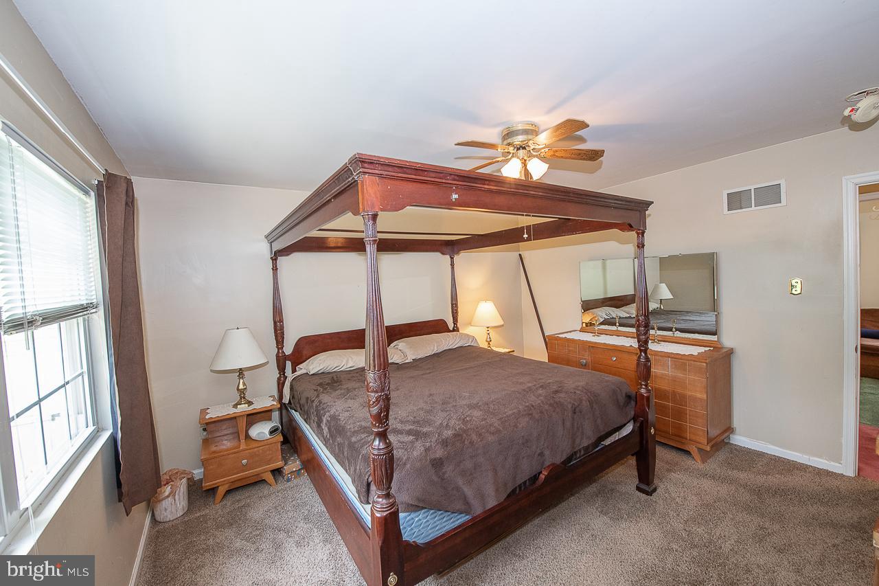527 Schick Road Aston, PA 19014 - Photo 20 of 28 a bedroom with a bed and a chandelier