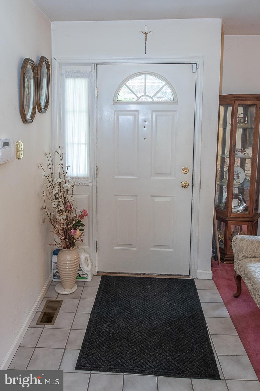527 Schick Road Aston, PA 19014 - Photo 7 of 28 a view of entryway with livingroom and chandelier