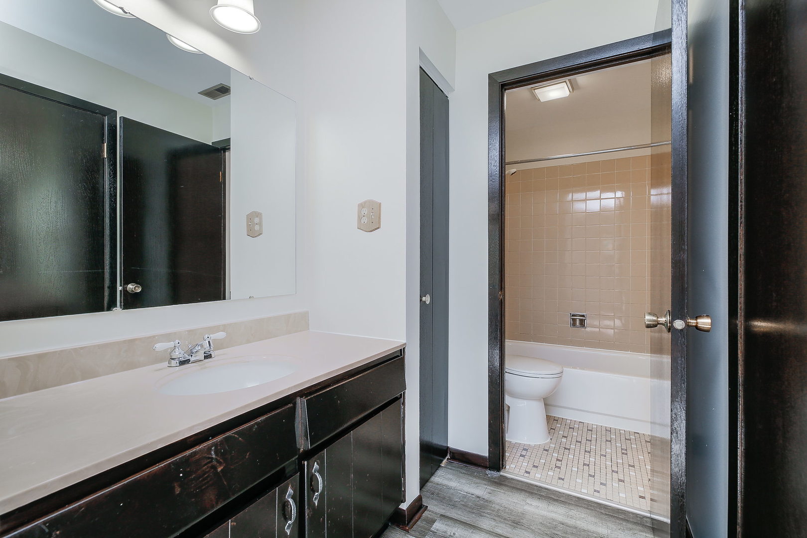 865 Sheldon Court, Unit C Wheaton, IL 60189 - Photo 12 of 17 a bathroom with a sink a toilet a tub and shower