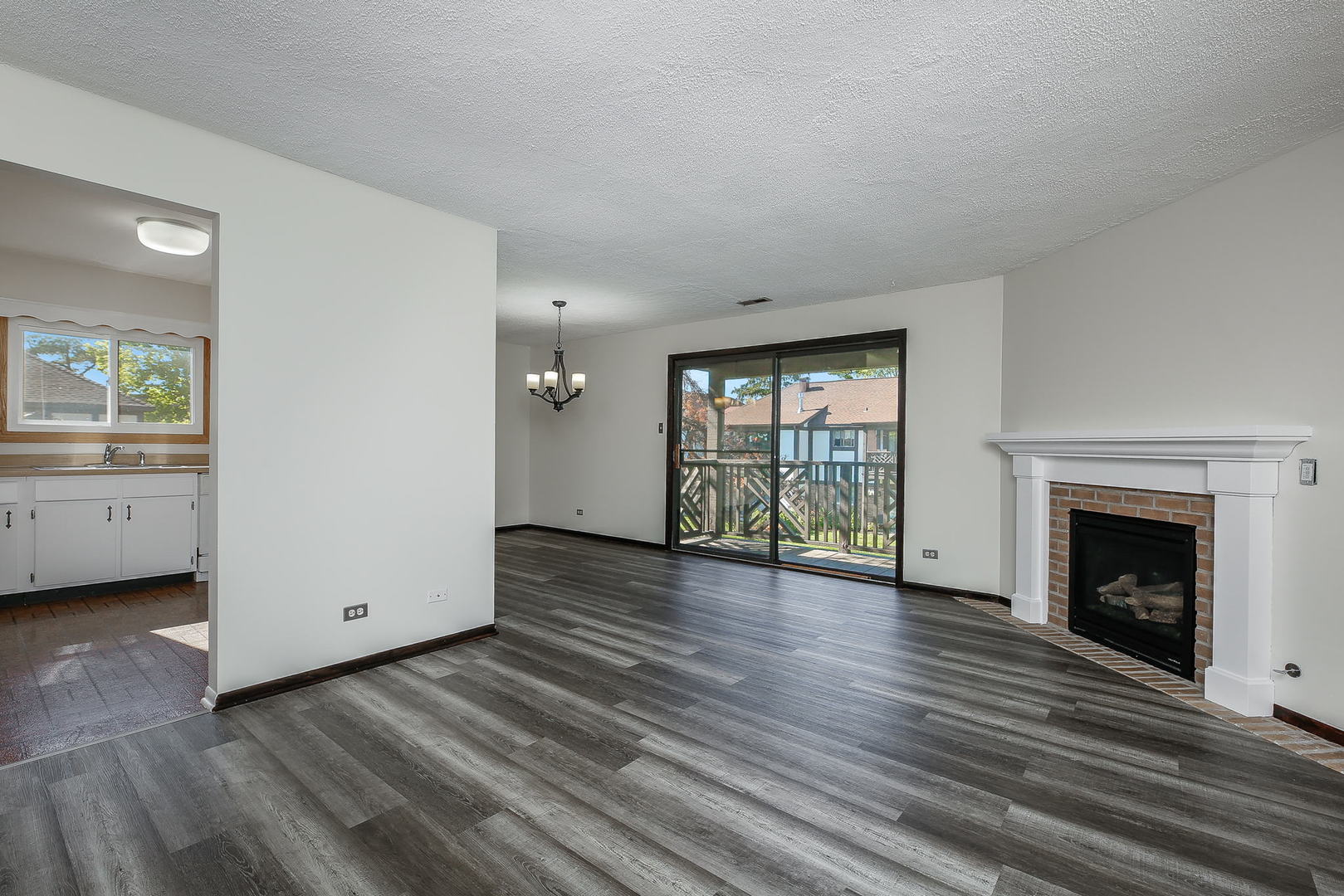 865 Sheldon Court, Unit C Wheaton, IL 60189 - Photo 2 of 17 a view of an empty room with window and wooden floor