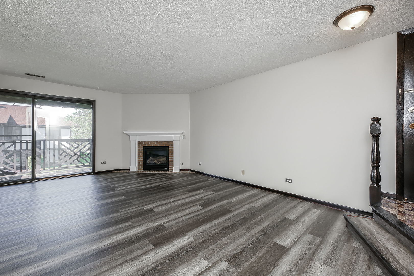 865 Sheldon Court, Unit C Wheaton, IL 60189 - Photo 5 of 17 wooden floor fireplace and natural light in room