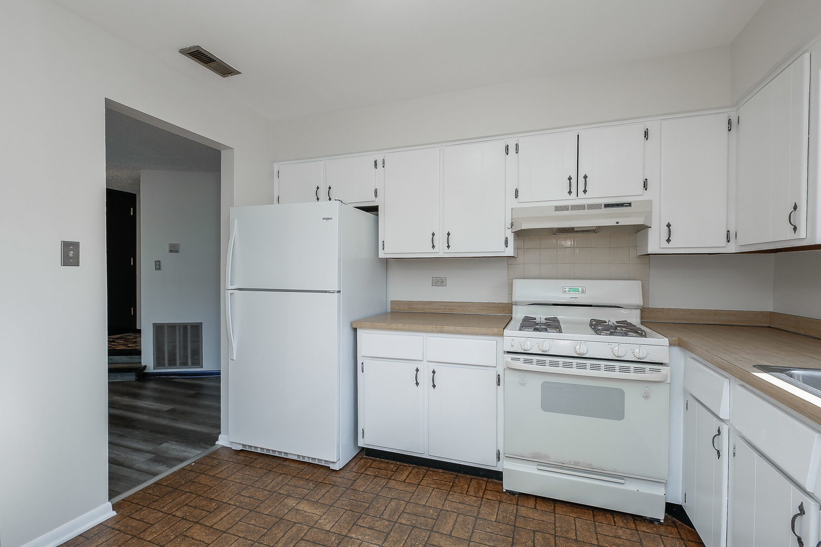 865 Sheldon Court, Unit C Wheaton, IL 60189 - Photo 7 of 17 a kitchen with white cabinets and white appliances