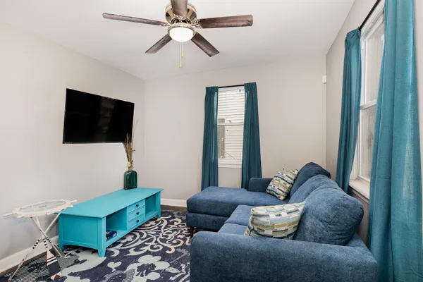 a living room with furniture and a flat screen tv