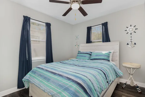 a bedroom with a bed and painting on the wall