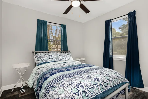 a bedroom with a large bed and a chandelier