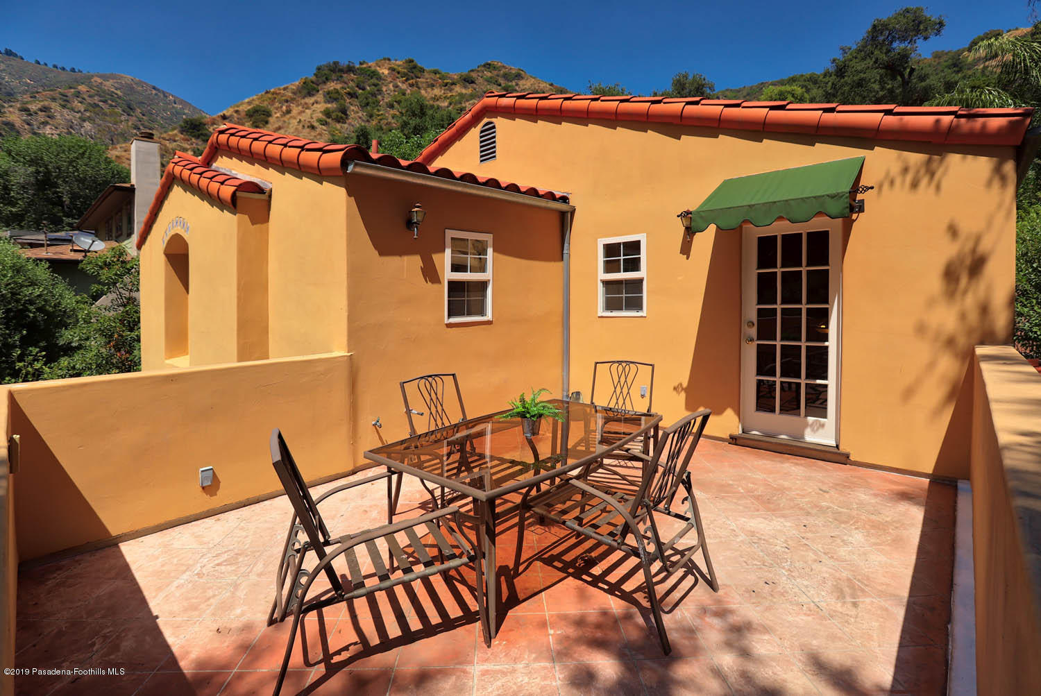 1934 Pasadena Glen Road Pasadena, CA 91107 - Photo 12 of 26 a view of a patio with table and chairs with wooden floor and fence