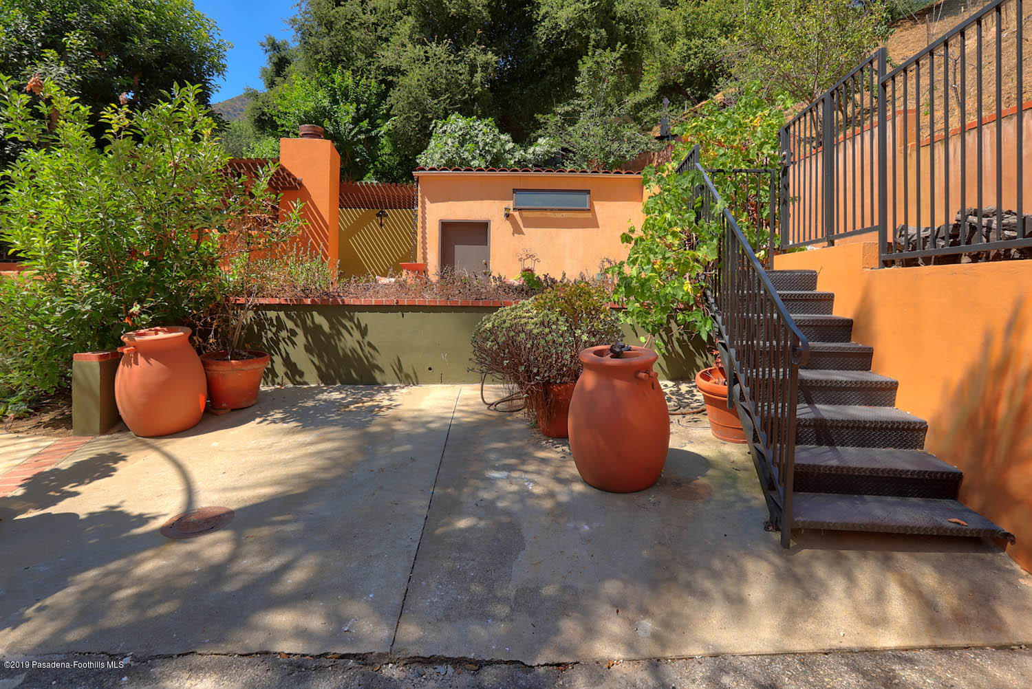 1934 Pasadena Glen Road Pasadena, CA 91107 - Photo 25 of 26 a view of a patio with table and chairs potted plants and large tree