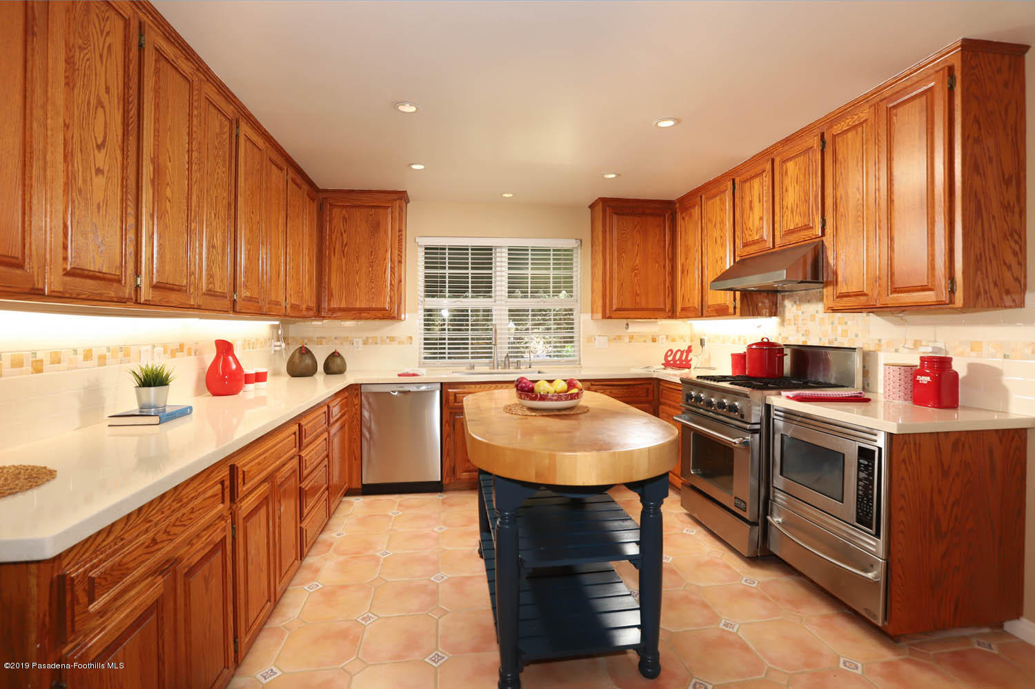 1934 Pasadena Glen Road Pasadena, CA 91107 - Photo 6 of 26 a kitchen with kitchen island granite countertop a sink stove top oven and cabinets