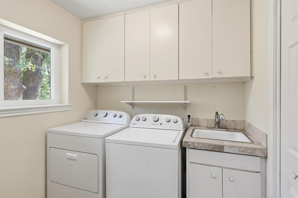 4000 Post Oak Road Flower Mound, TX 75022 - Photo 22 of 40 Main house - Laundry room with plenty of space for washer and dryer with sink, cabinets, shelf, and storage closet to the right