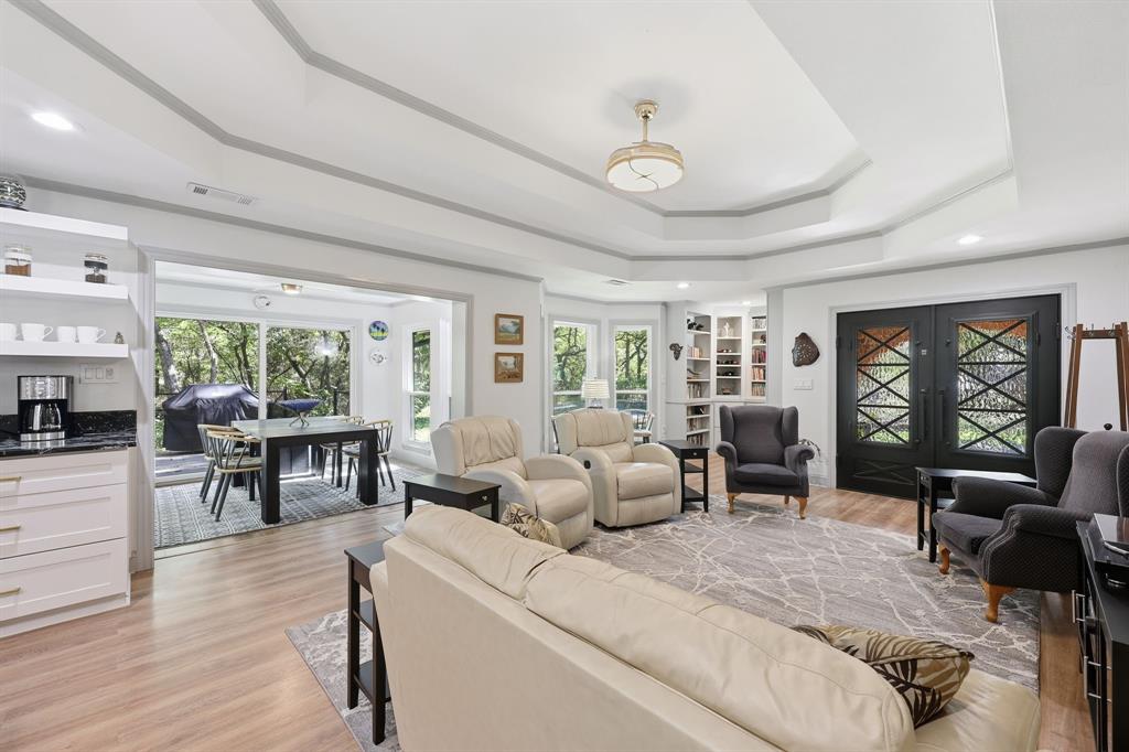 4000 Post Oak Road Flower Mound, TX 75022 - Photo 24 of 40 Guest House - Living room looking toward the front entrance featuring a book nook, bay windows, and a tray ceiling