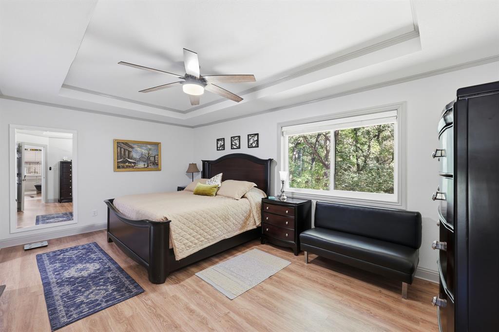 4000 Post Oak Road Flower Mound, TX 75022 - Photo 32 of 40 Guest house - Primary bedroom with a raised ceiling, ceiling fan, closet with double doors, and en suite bathroom