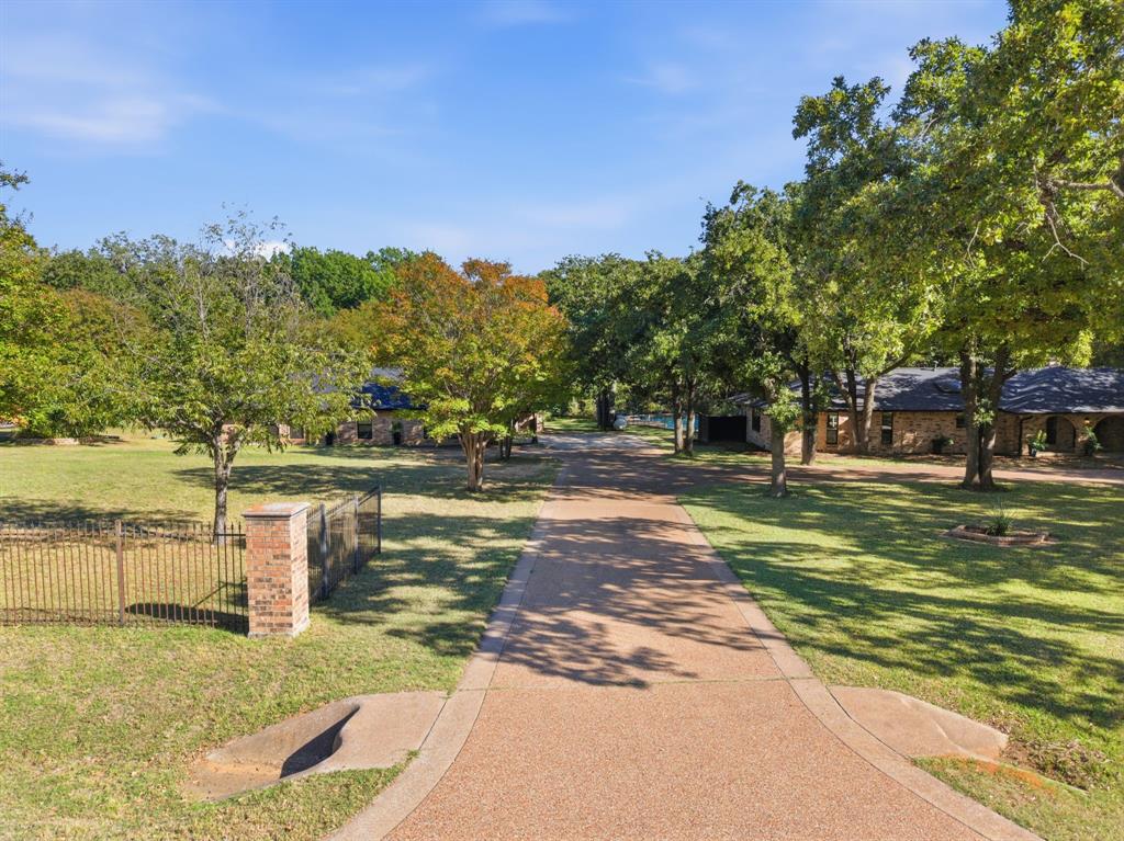 4000 Post Oak Road Flower Mound, TX 75022 - Photo 36 of 40 View of the first entrance of the semi-circular driveway leading to the guest house on the left and the main house on the right