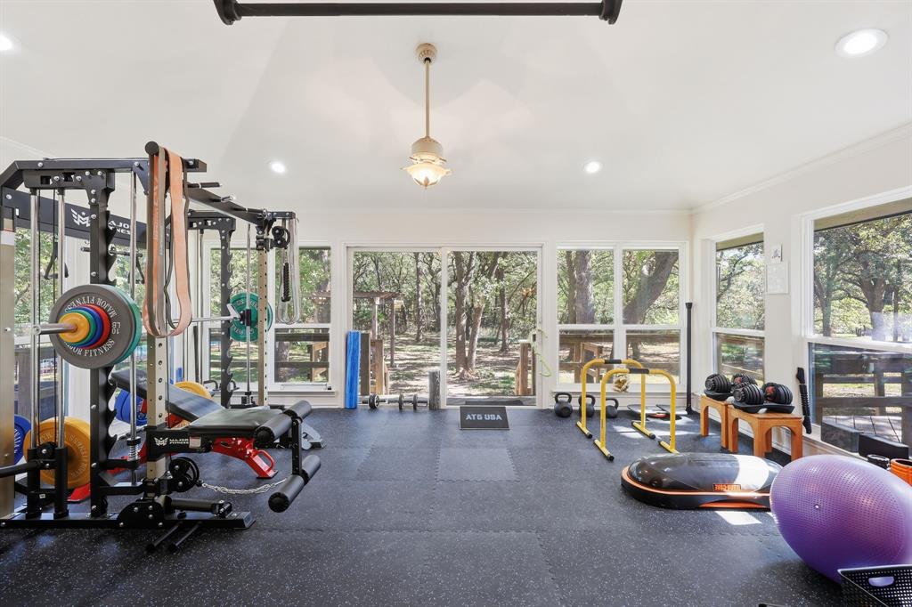 4000 Post Oak Road Flower Mound, TX 75022 - Photo 9 of 40 Main house - Expansive sun room flowing with natural lighting. Gym floor mats will be removed revealing the stunning tile that matches the entryway.