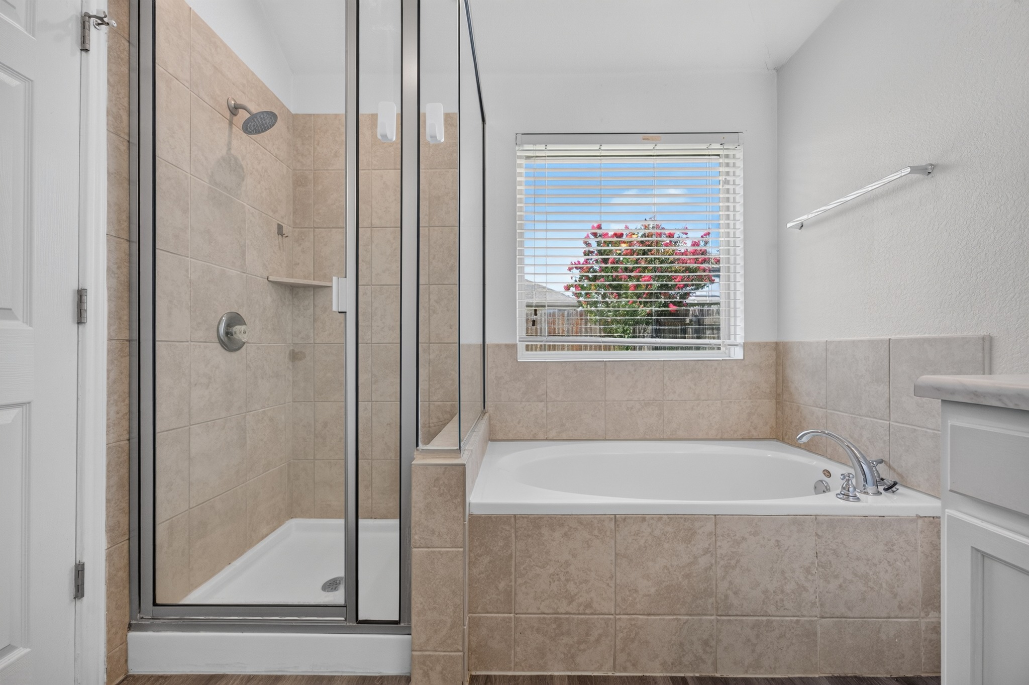 278 Noddy Road Buda, TX 78610 - Photo 14 of 17 Tiled bath and shower with a window above, offering a peaceful retreat.