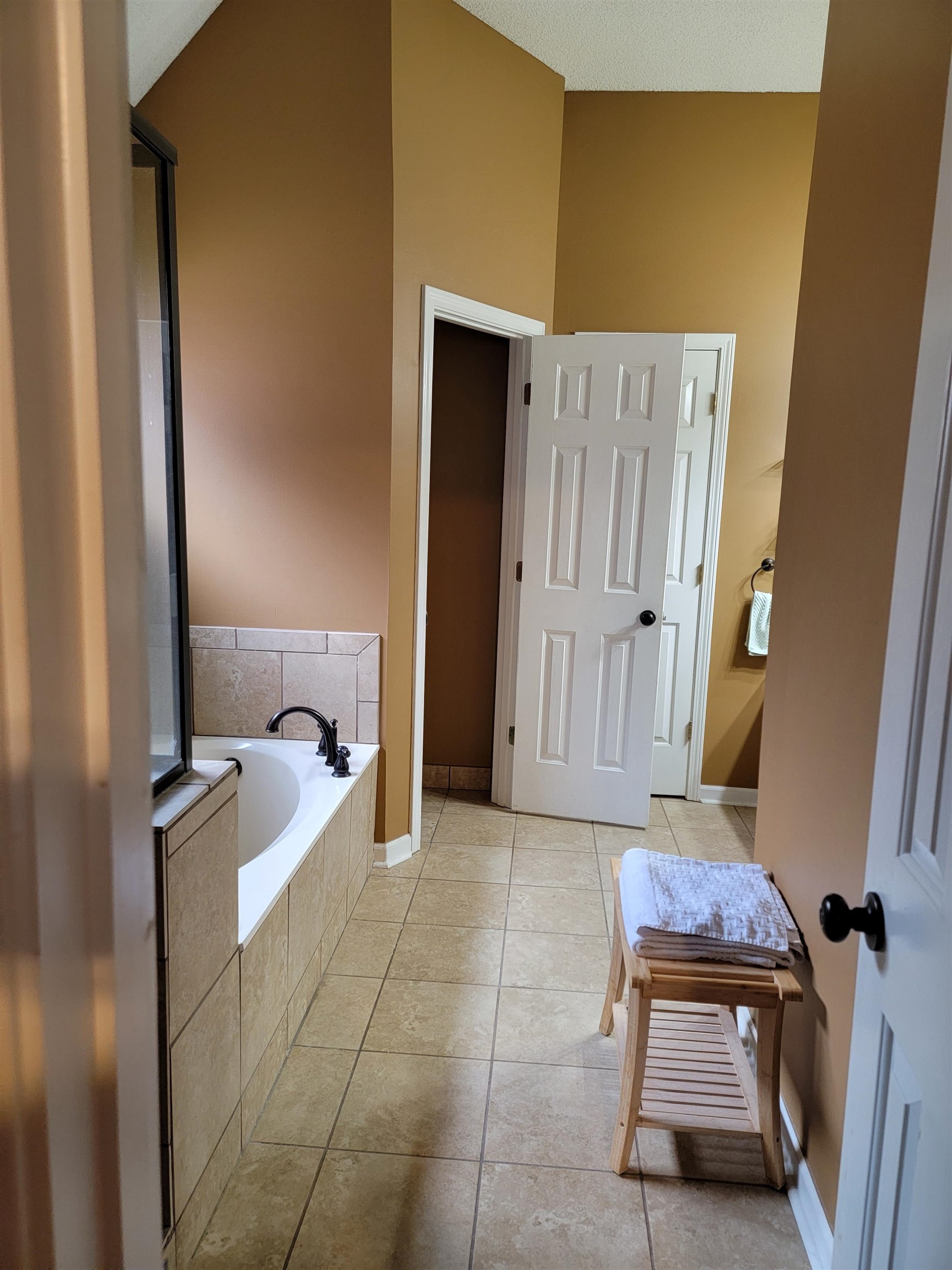 7926 Macon Road Cordova, TN 38018 - Photo 14 of 15 Full bathroom featuring a bath, light tile patterned floors, and high vaulted ceiling