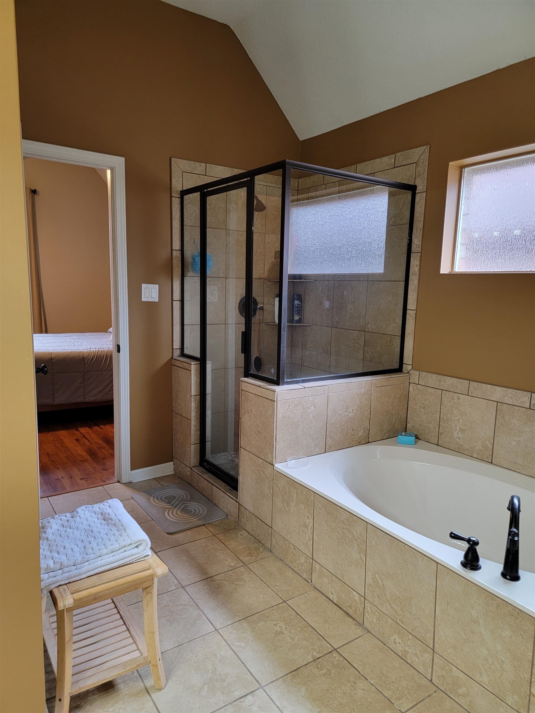 7926 Macon Road Cordova, TN 38018 - Photo 15 of 15 Bathroom featuring a stall shower, tile patterned flooring, a bath, lofted ceiling, and connected bathroom