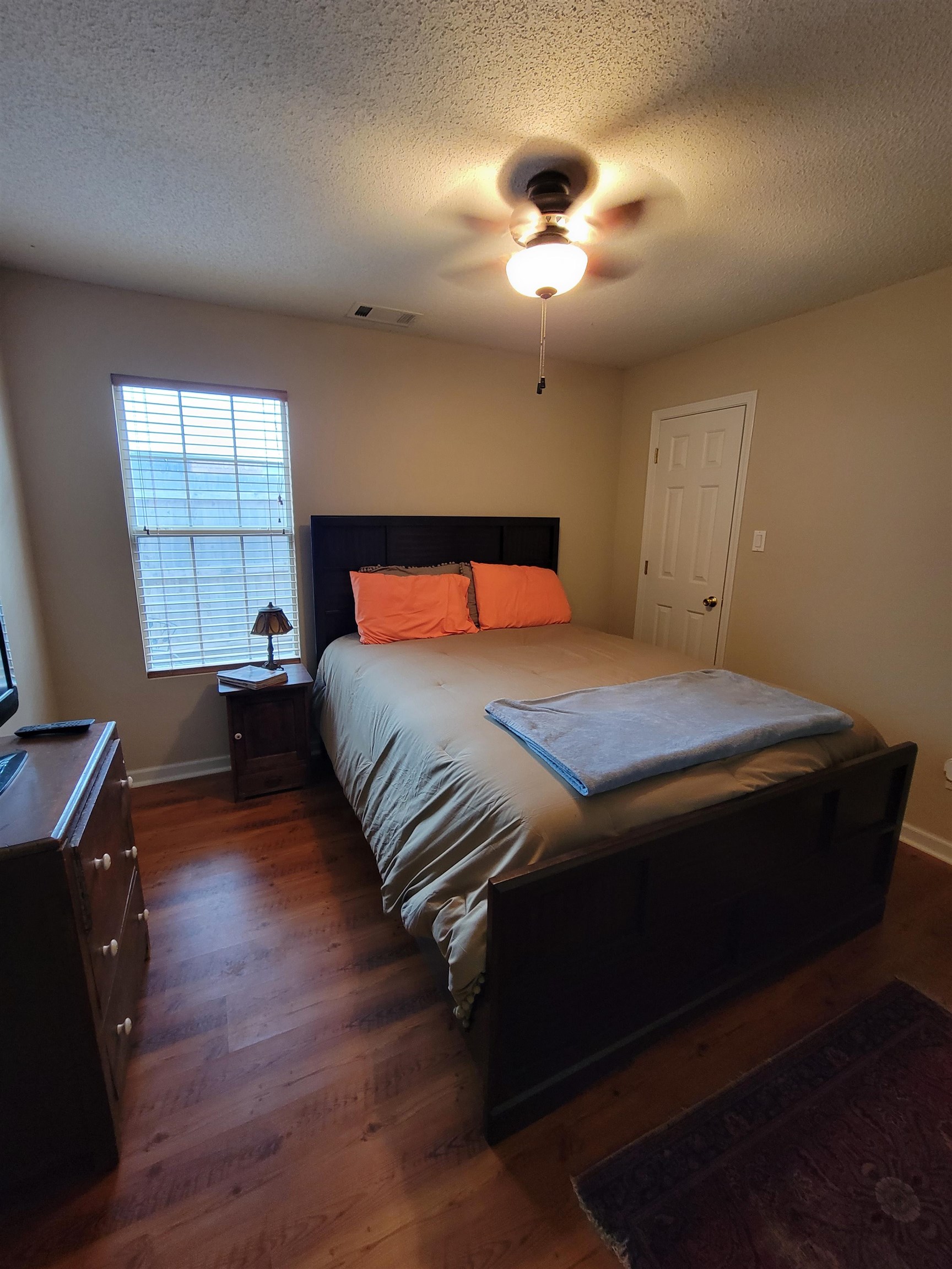 7926 Macon Road Cordova, TN 38018 - Photo 6 of 15 Bedroom featuring a textured ceiling, a ceiling fan, and dark wood-style flooring