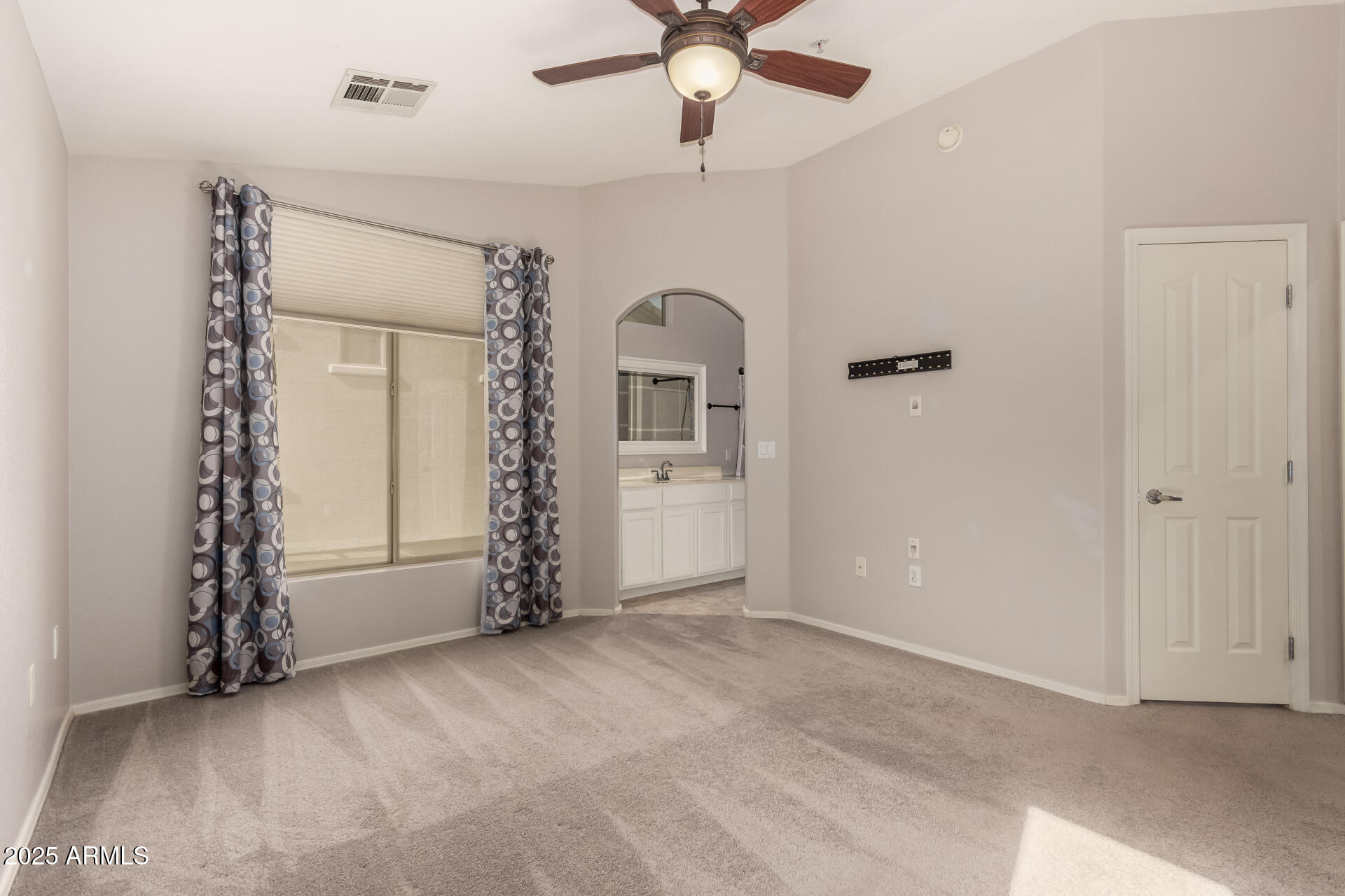 2150 West Alameda Road, Unit 1024 Phoenix, AZ 85085 - Photo 11 of 24 an empty room with chandelier fan and windows