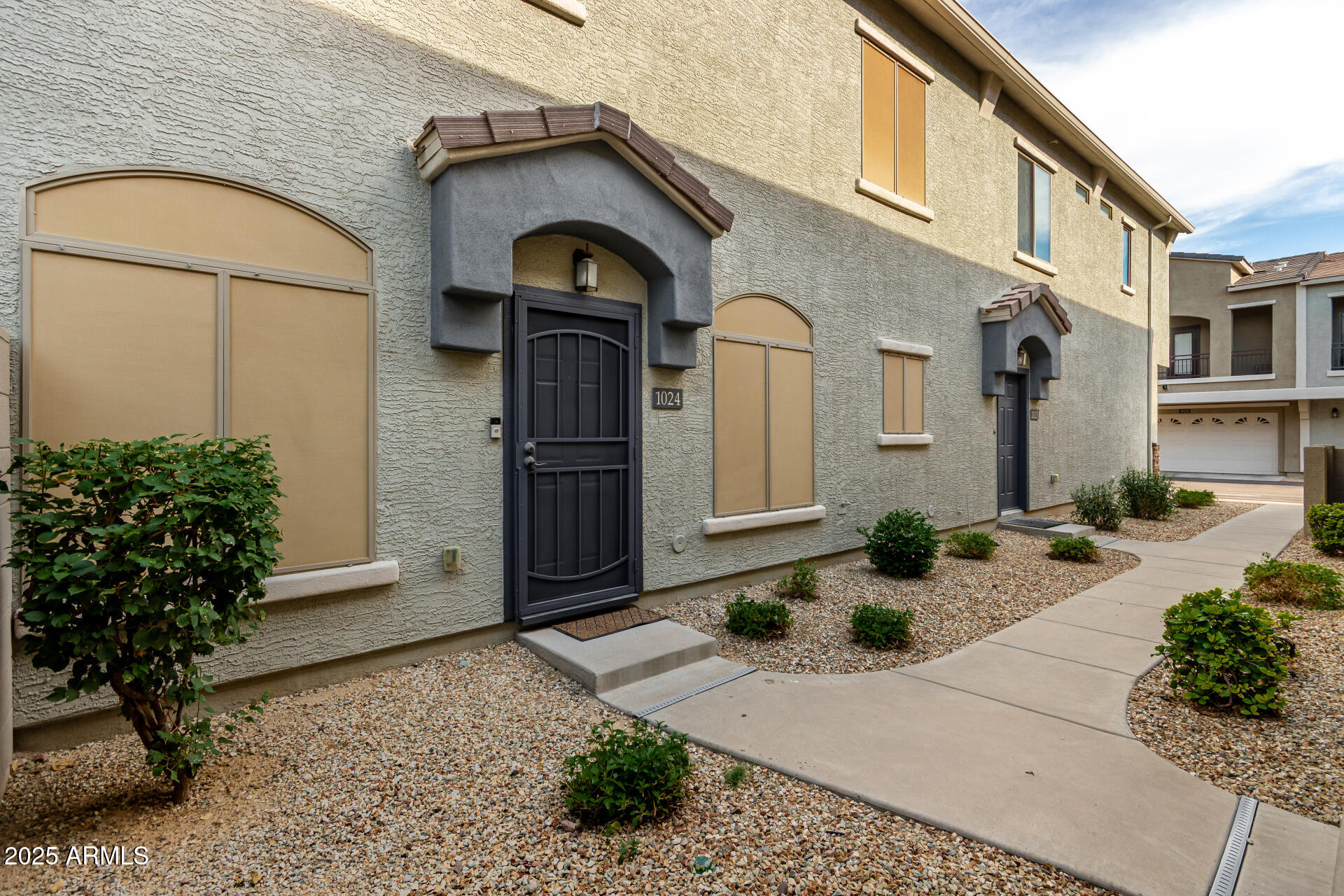 2150 West Alameda Road, Unit 1024 Phoenix, AZ 85085 - Photo 3 of 24 a front view of a house with garden