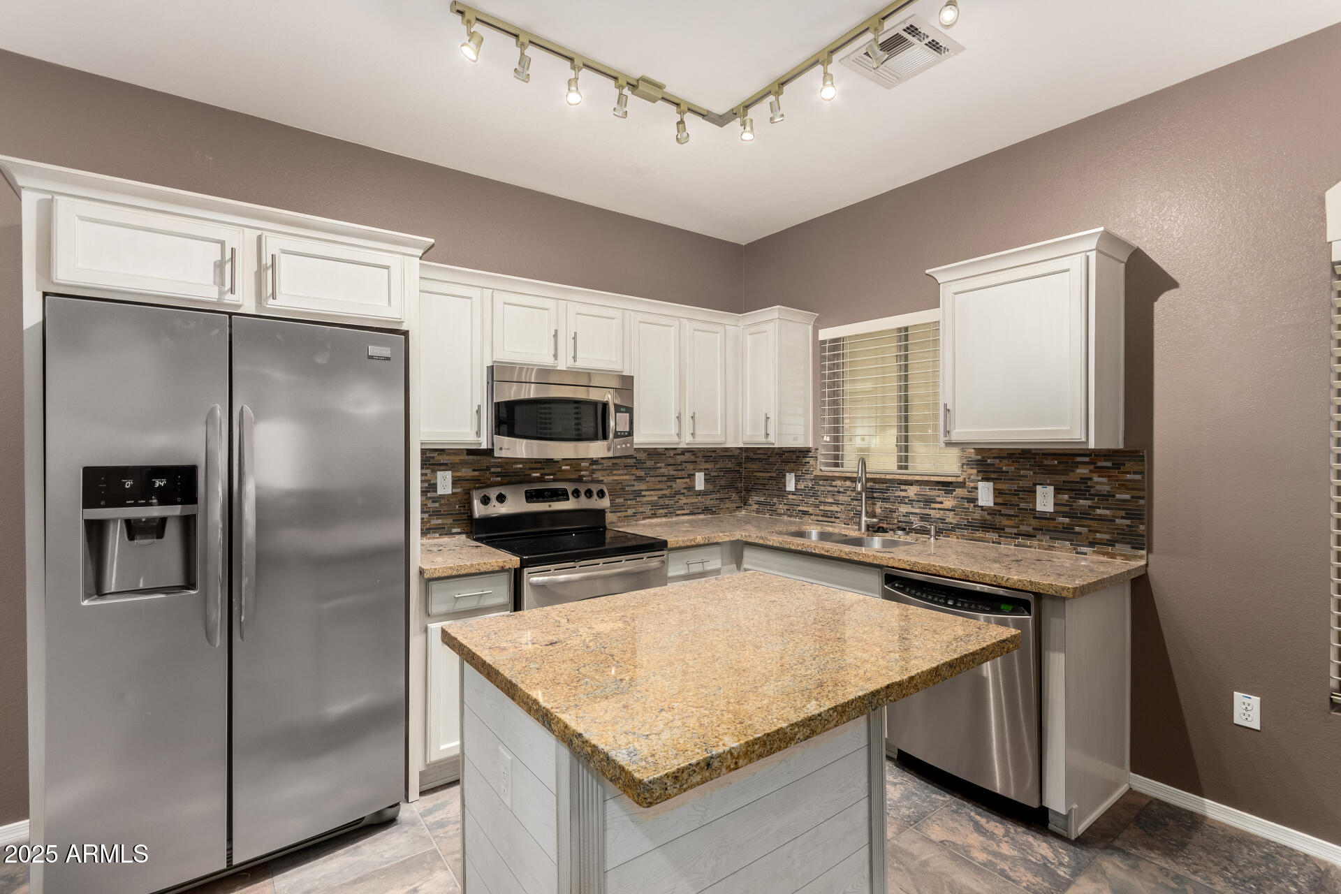 2150 West Alameda Road, Unit 1024 Phoenix, AZ 85085 - Photo 4 of 24 a kitchen with stainless steel appliances granite countertop a sink a stove a refrigerator and a microwave