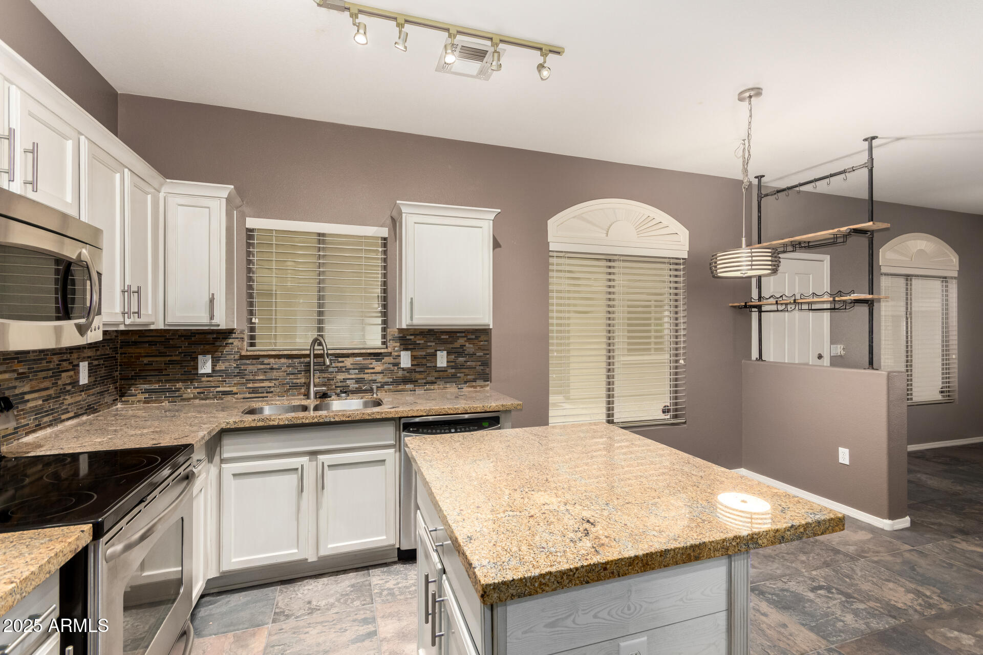 2150 West Alameda Road, Unit 1024 Phoenix, AZ 85085 - Photo 6 of 24 a kitchen with stainless steel appliances granite countertop cabinets and window