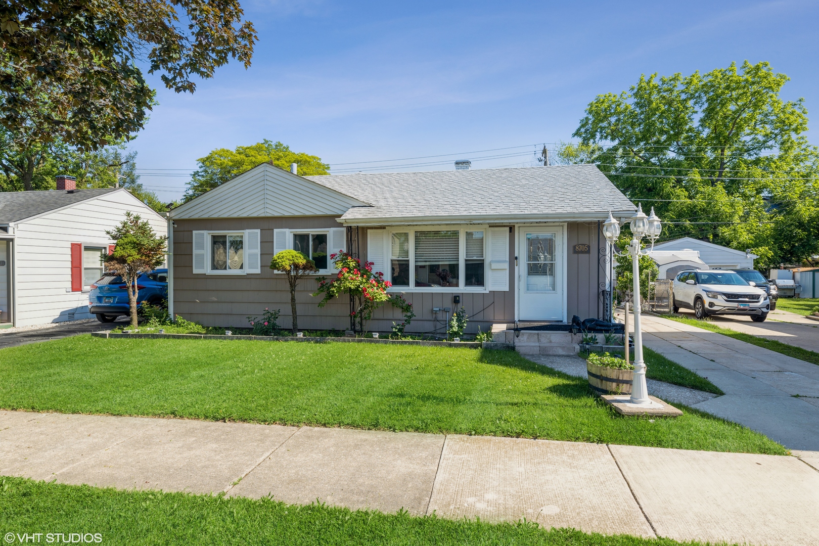 8705 45th Street Lyons, IL 60534 - Photo 2 of 19 a front view of a house with a yard and garage