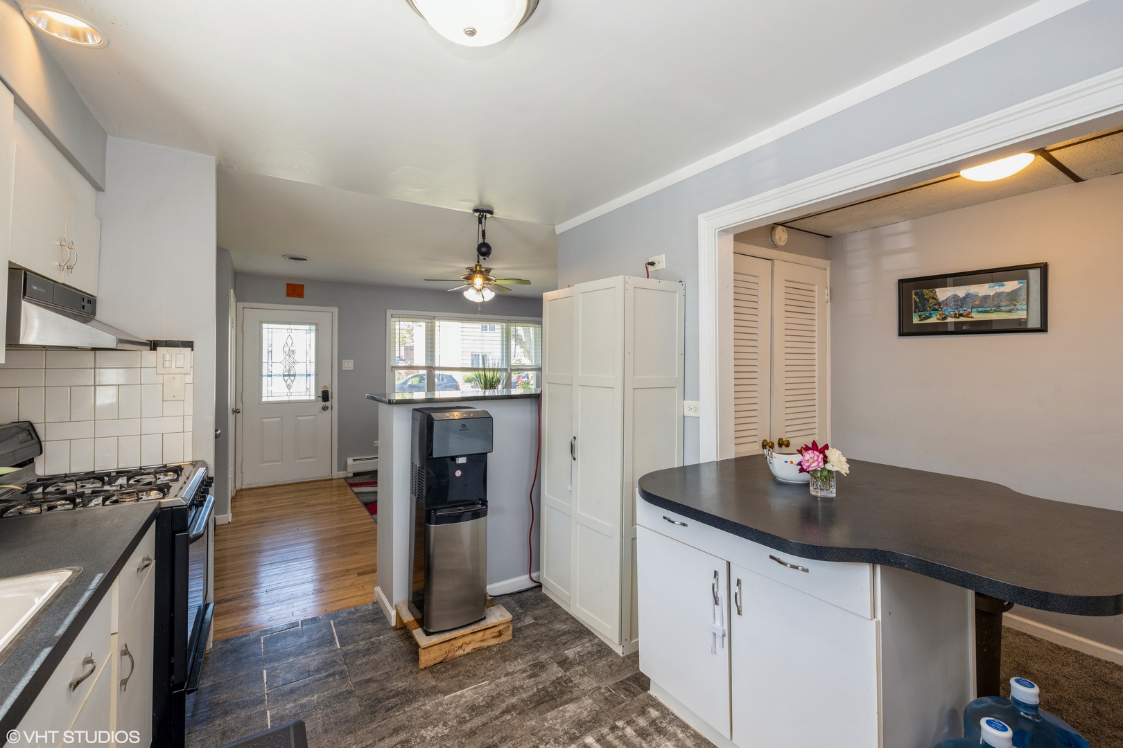 8705 45th Street Lyons, IL 60534 - Photo 7 of 19 a kitchen with granite countertop a sink cabinets and wooden floor