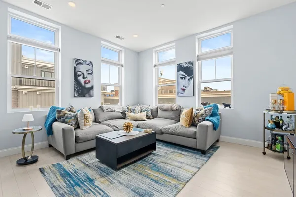 a living room with furniture wooden floor and a window