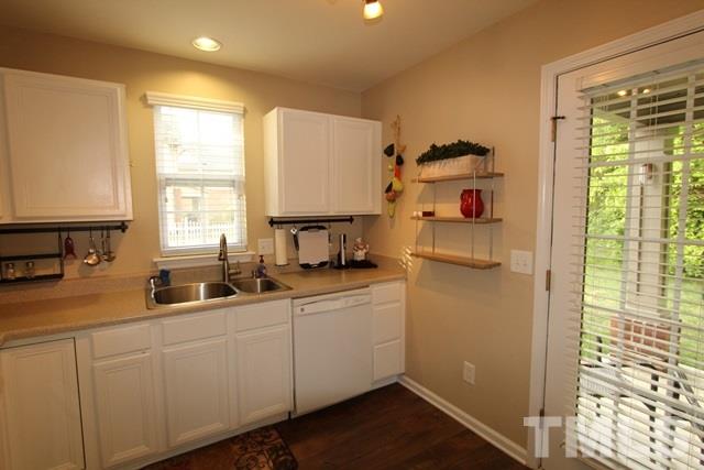 9914 Reanne Court Raleigh, NC 27617 - Photo 11 of 25 a kitchen with cabinets a window and appliances