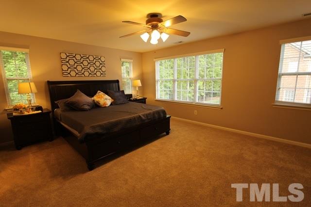 9914 Reanne Court Raleigh, NC 27617 - Photo 13 of 25 a bedroom with a bed and window