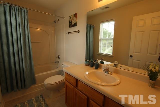 9914 Reanne Court Raleigh, NC 27617 - Photo 18 of 25 a bathroom with a sink toilet and shower